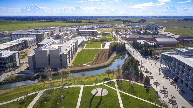 UC Merced campus aerial view with the Beginnings sculpture and surrounding waterways