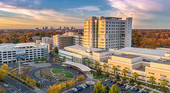 UC Davis Health campus at sunset with the Sacramento skyline in the distance